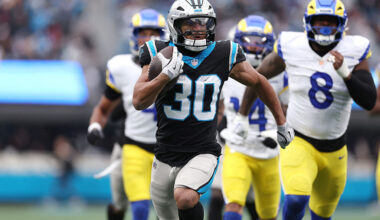 CHARLOTTE, NORTH CAROLINA - NOVEMBER 30: Chuba Hubbard #30 of the Carolina Panthers carries the ball and scores a touchdown against the Los Angeles Rams during the first quarter at Bank of America Stadium on November 30, 2025 in Charlotte, North Carolina. (Photo by David Jensen/Getty Images)