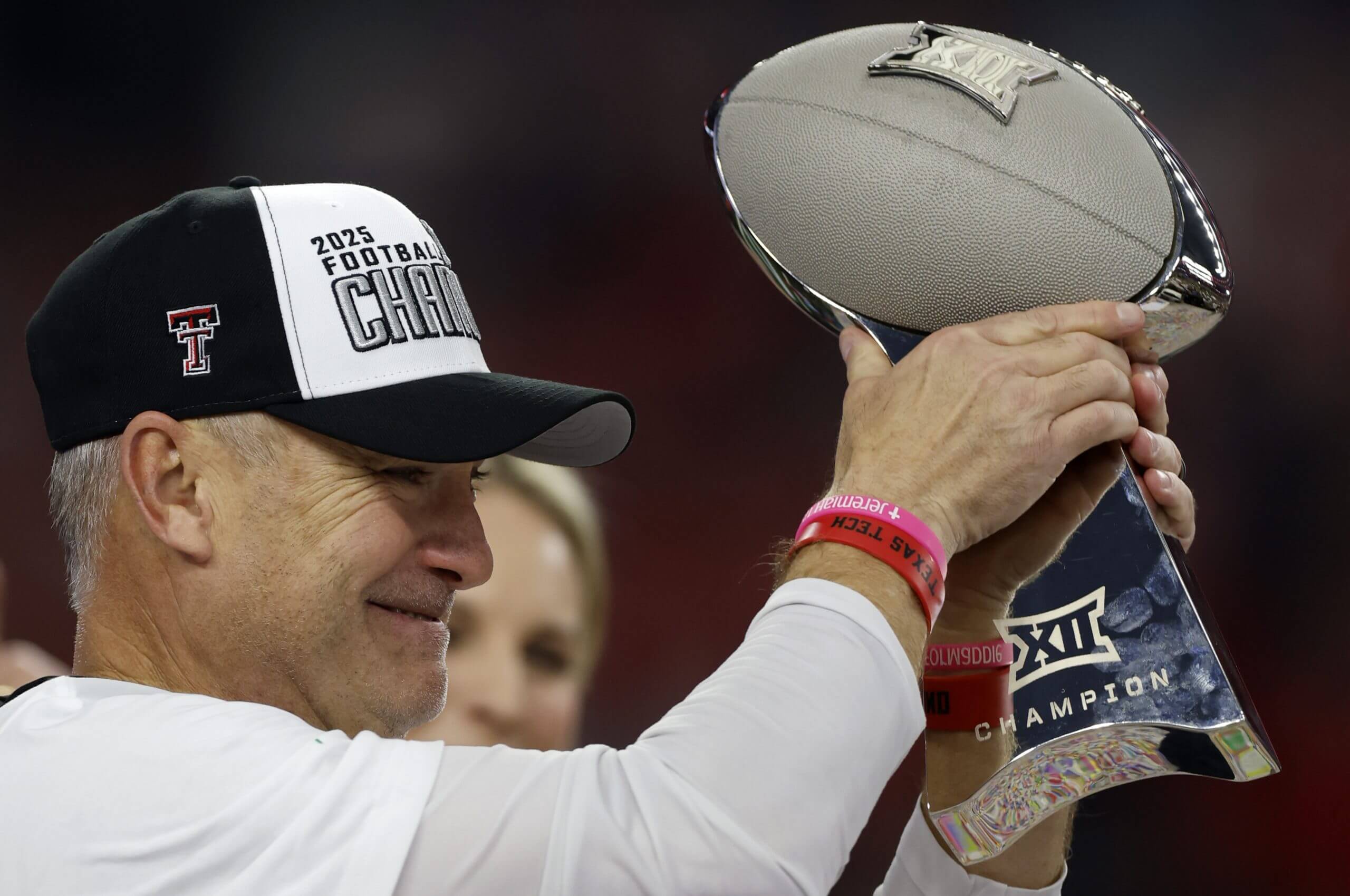 Texas Tech head coach Joey McGuire holds up the Big 12 championship trophy.
