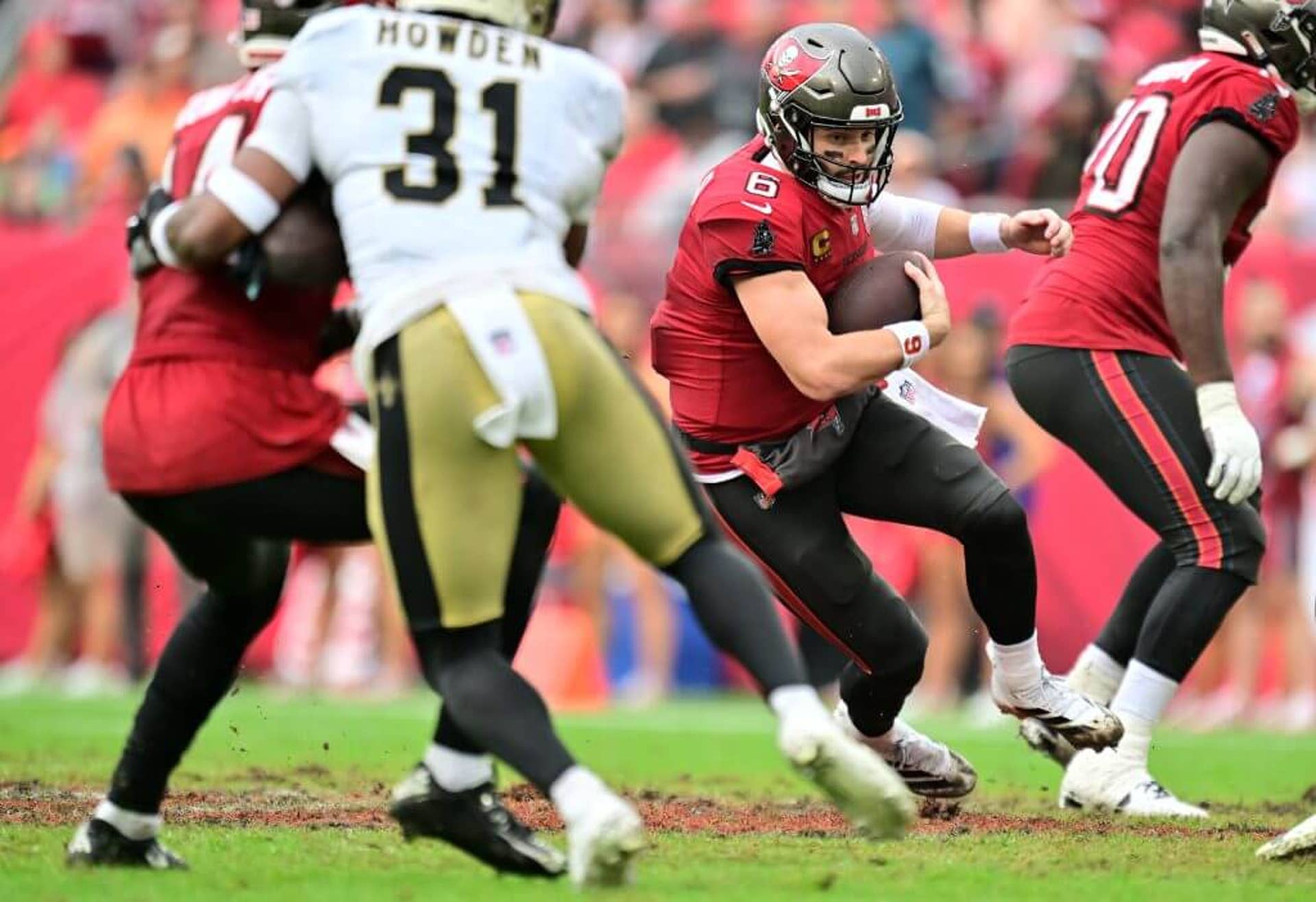 Baker Mayfield #6 of the Tampa Bay Buccaneers scrambles with the ball against the New Orleans Saints at Raymond James Stadium