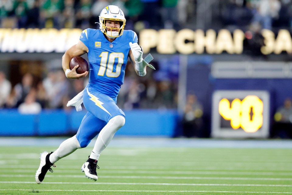 Justin Herbert #10 of the Los Angeles Chargers runs with the ball during the third quarter against the Philadelphia Eagles at SoFi Stadium