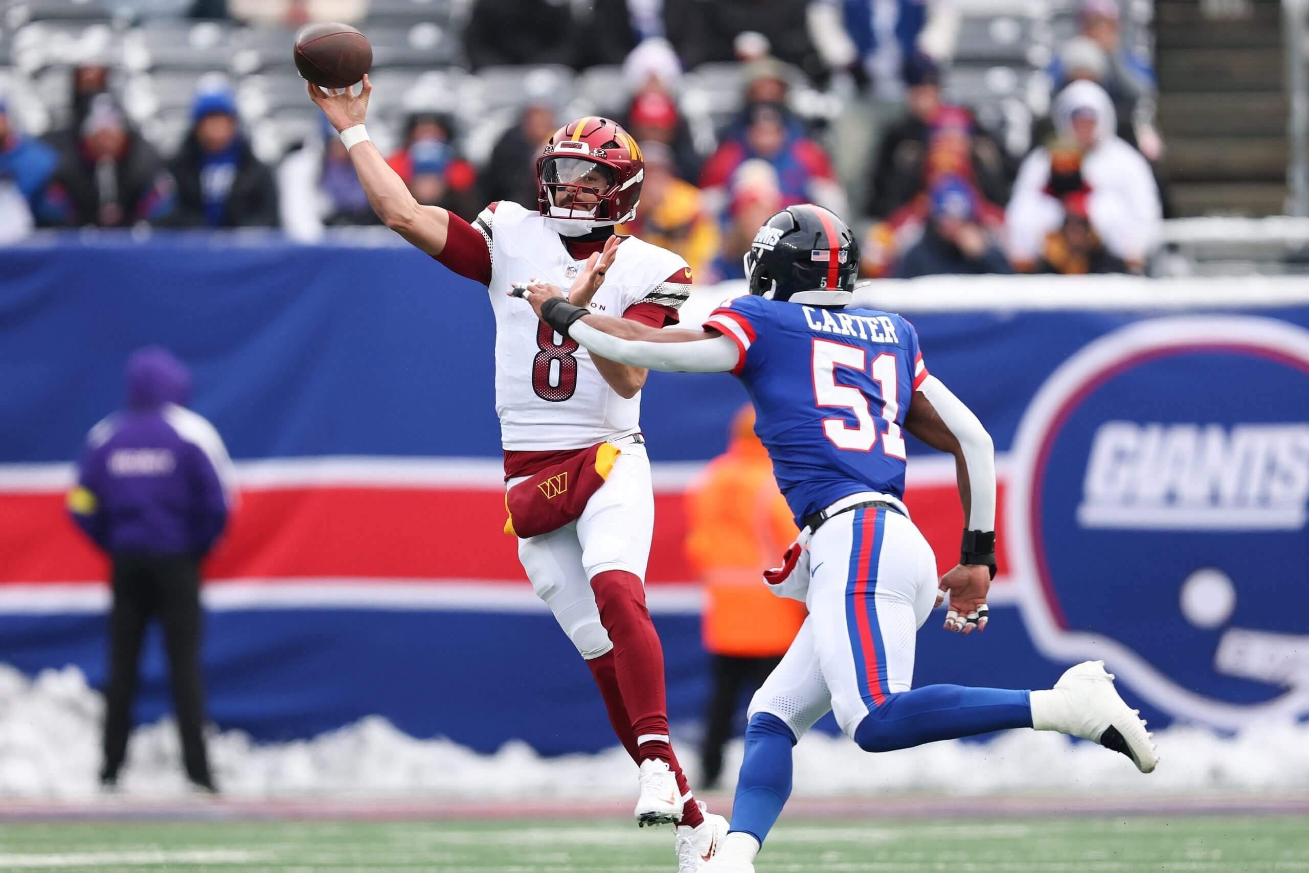 Marcus Mariota #8 of the Washington Commanders attempts a pass while rushed by Abdul Carter #51 of the New York Giants during the first quarter at MetLife Stadium on Dec. 14.
