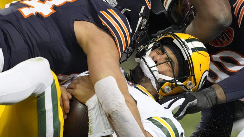 CHICAGO, ILLINOIS - DECEMBER 20: Jordan Love #10 of the Green Bay Packers is hit by Austin Booker #94 of the Chicago Bears during the second quarter against the Chicago Bears at Soldier Field on December 20, 2025 in Chicago, Illinois. (Photo by Patrick McDermott/Getty Images)