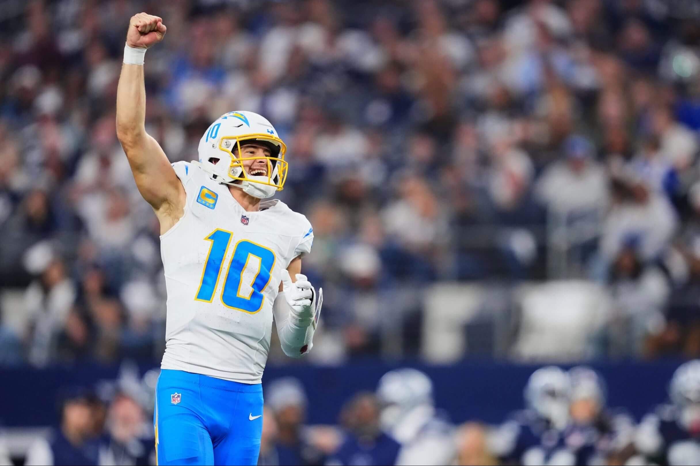 Justin Herbert #10 of the Los Angeles Chargers celebrates after scoring a touchdown against the Dallas Cowboys during a game at AT&T Stadium on Dec. 21.