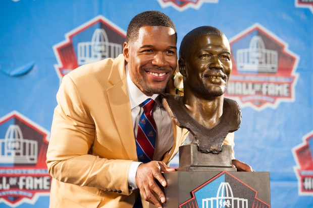 CANTON, OH - AUGUST 2: Former New York Giants defensive end Michael Strahan with his bust during the NFL Class of 2014 Pro Football Hall of Fame Enshrinement Ceremony at Fawcett Stadium on August 2, 2014 in Canton, Ohio. (Photo by Jason Miller/Getty Images)
