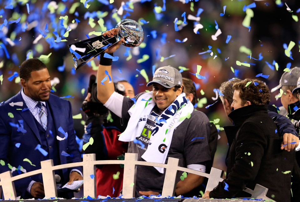 Russell Wilson #3 of the Seattle Seahawks celebrates with the Vince Lombardi trophy after defeating the Denver Broncos 43-8 in Super Bowl XLVIII