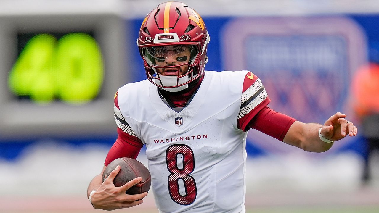 Washington Commanders quarterback Marcus Mariota carried the ball against the New York Giants on Sunday in East Rutherford, N.J.