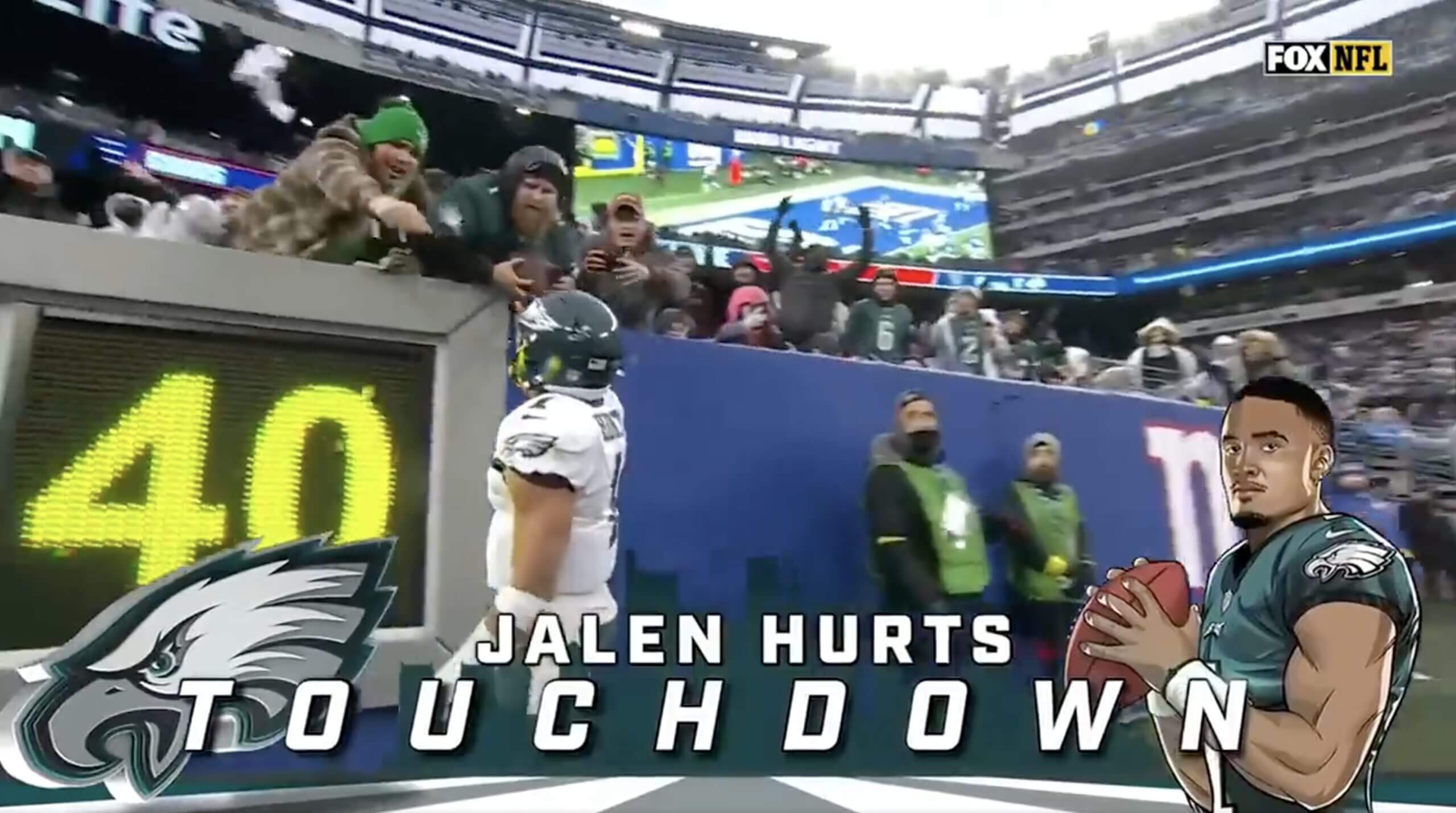 A screenshot of the Fox broadcast shows Jalen Hurts handed a football to Philadelphia Eagles fan Paul Hamilton after scoring a touchdown against the New York Giants at MetLife Stadium on Dec. 11, 2022.