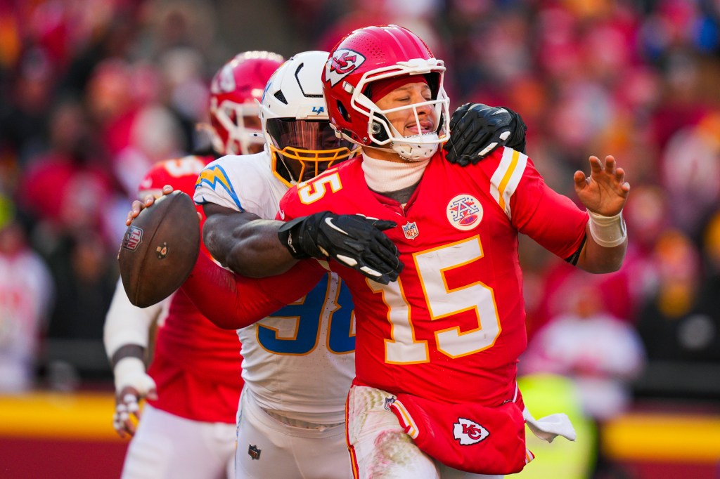 Los Angeles Chargers linebacker Odafe Oweh (98) sacks Kansas City Chiefs quarterback Patrick Mahomes (15) during the second half at GEHA Field at Arrowhead Stadium. 