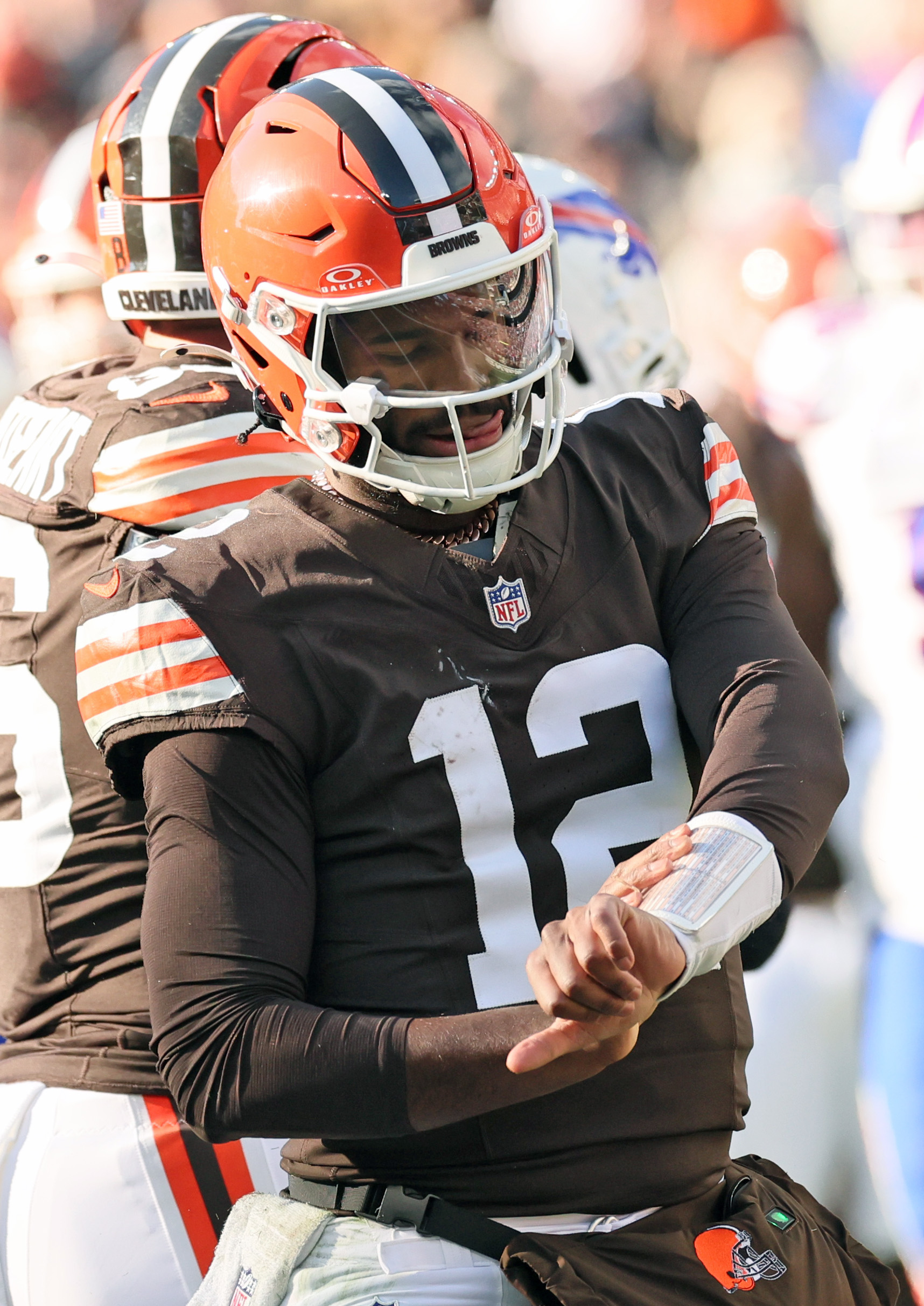 Cleveland Browns quarterback Shedeur Sanders celebrates his first down rush in the first half by grabbing his play sheet on his wrist.  