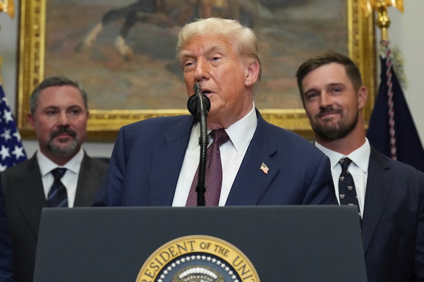President Donald Trump speaks as Cody Campbell, left, and professional golfer Bryson...