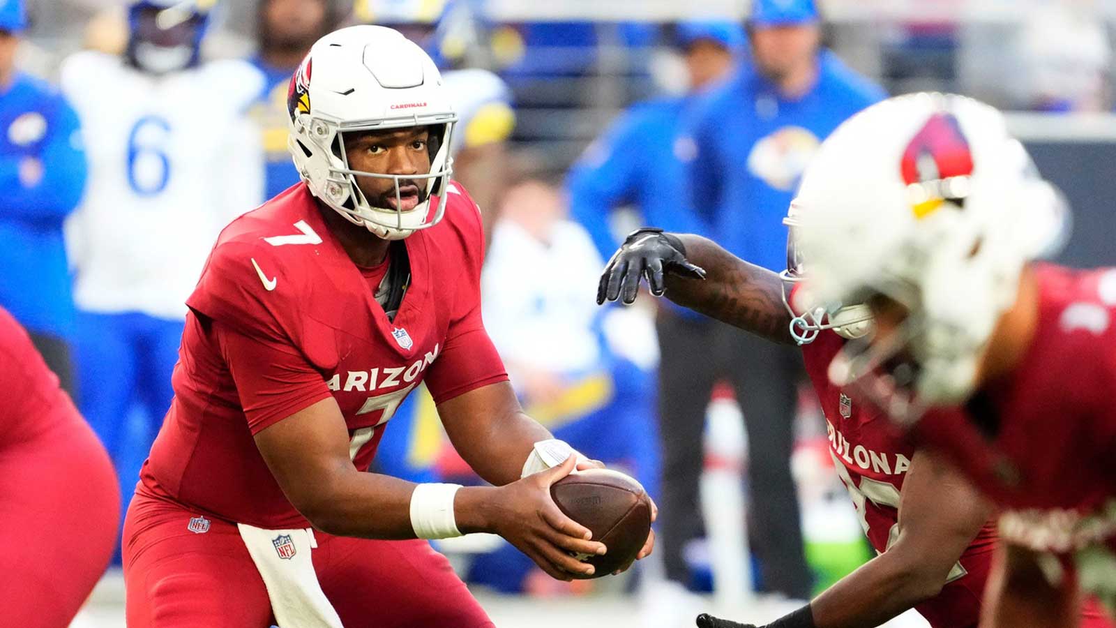 Arizona Cardinals quarterback Jacoby Brissett (7) hands off the ball against the Los Angeles Rams in the first half at State Farm Stadium on Dec 7, 2025, in Glendale, Ariz.
