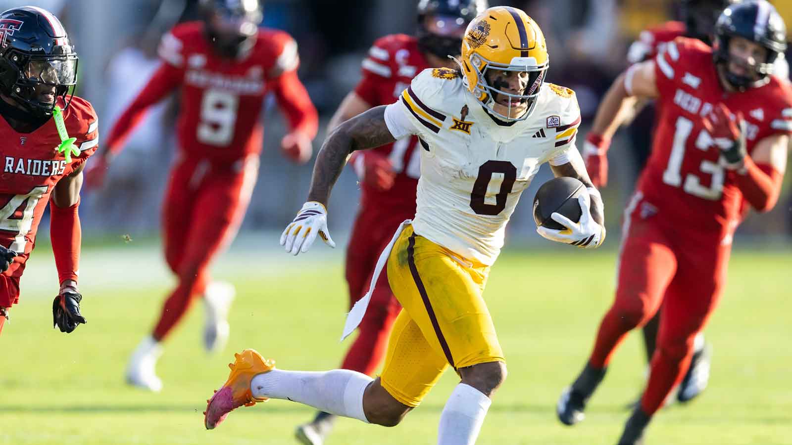 Arizona State Sun Devils wide receiver Jordyn Tyson (0) runs for a touchdown against Utah Utes cornerback Smith Snowden (2) during the third quarter at Rice-Eccles Stadium.
