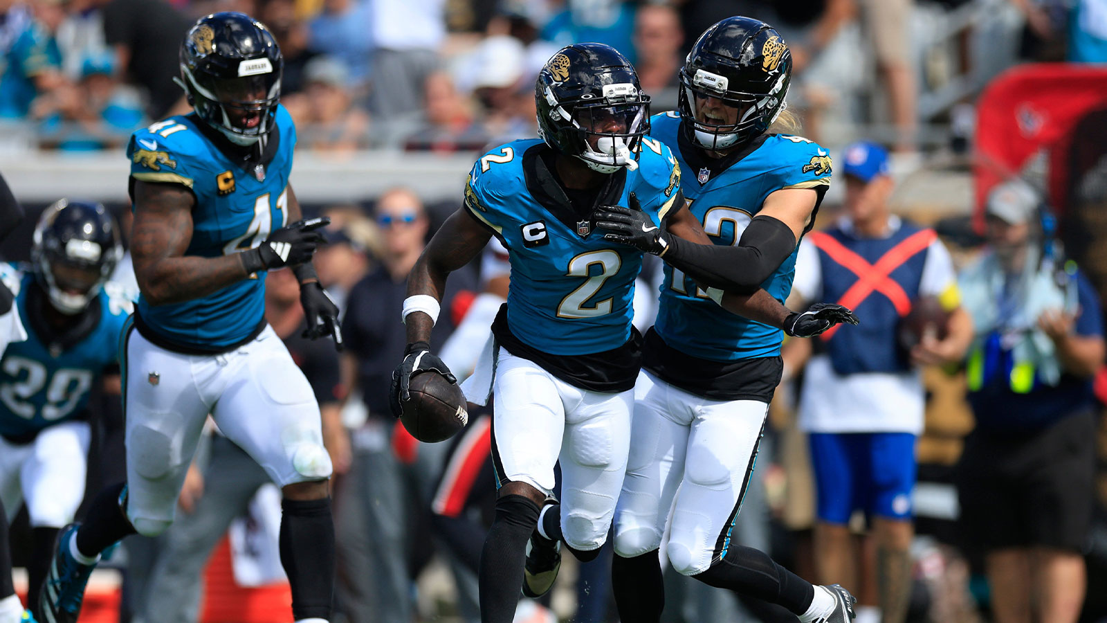 Jacksonville Jaguars cornerback Jourdan Lewis (2) celebrates his interception with safety Andrew Wingard (42), right, and defensive end Josh Hines-Allen (41), left, during the fourth quarter of an NFL football matchup at EverBank Stadium, Sunday, Sept. 21, 2025, in Jacksonville, Fla. The Jaguars defeated the Texans 17-10.