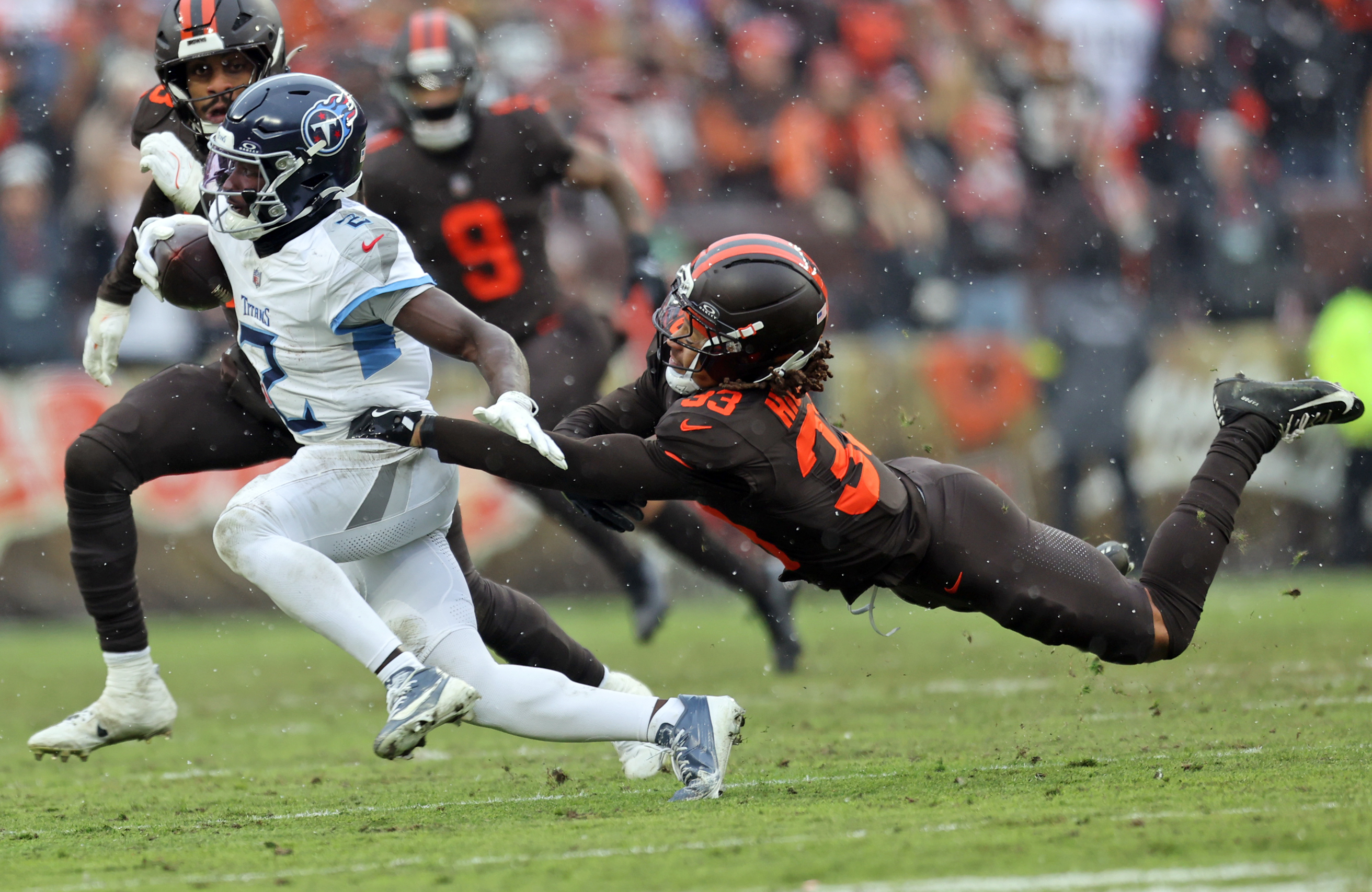 Tennessee Titans running back Tyjae Spears runs the ball as Cleveland Browns safety Ronnie Hickman tries to tackle him in the first half of play. 