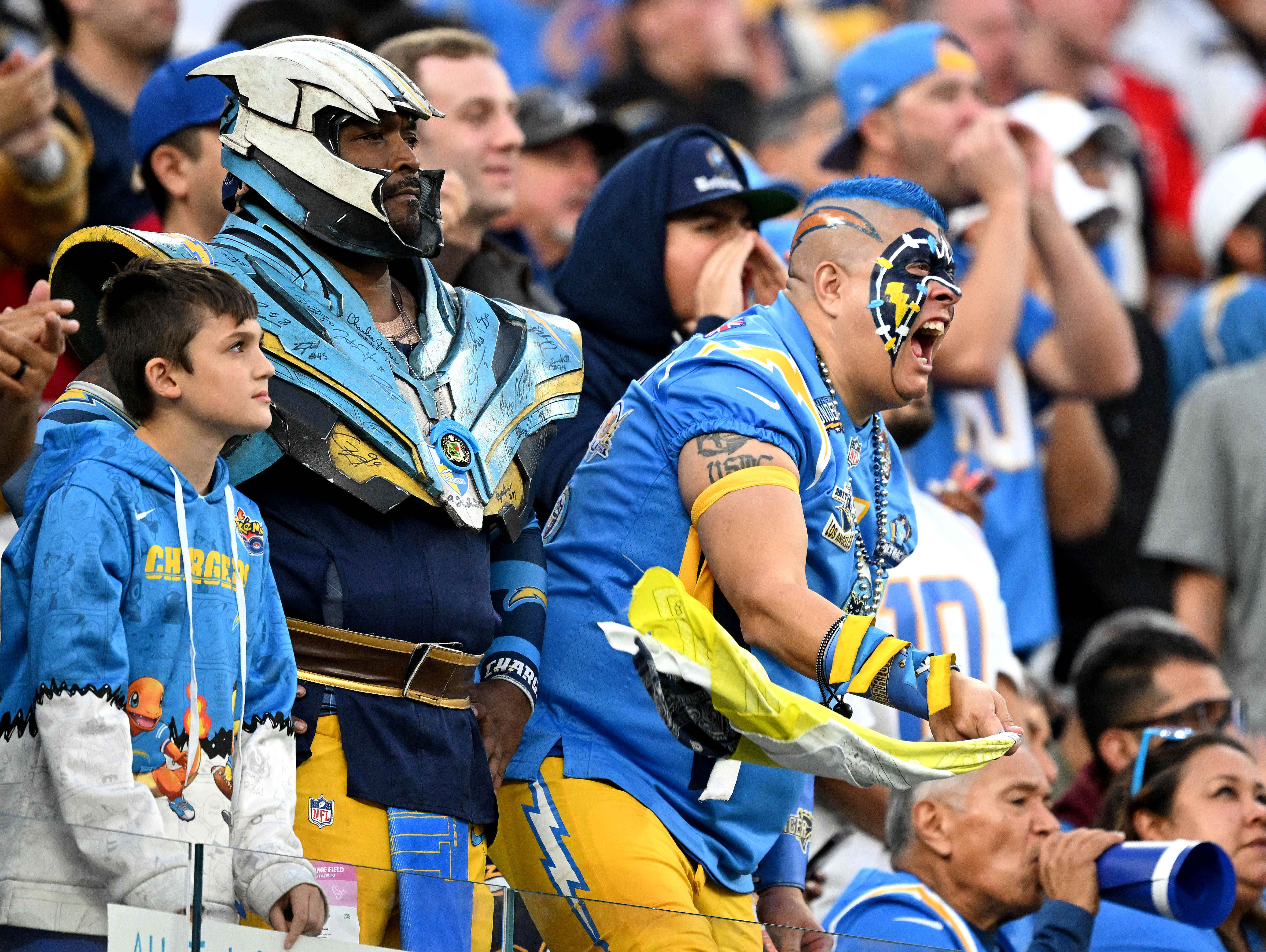 Charger fans cheer during the second half at SoFi Stadium...