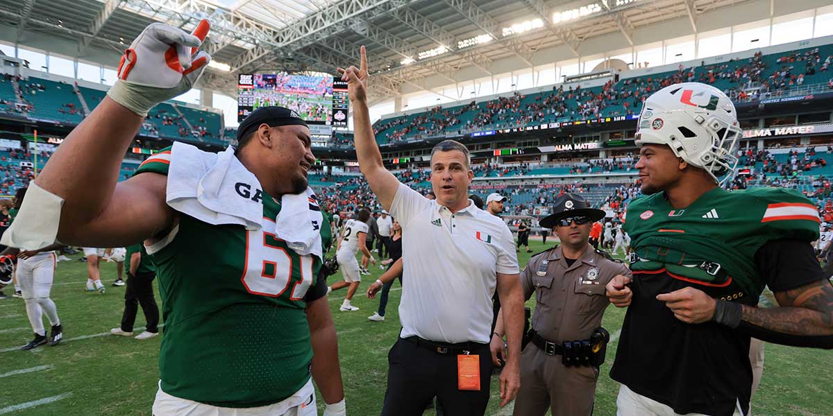 Nov 23, 2024; Miami Gardens, Florida, USA; Miami Hurricanes head coach Mario Cristobal celebrates with Miami Hurricanes offensive lineman Francis Mauigoa (61) and tight end Elijah Arroyo (8) after the game against the Wake Forest Demon Deacons at Hard Rock Stadium. Mandatory Credit: Sam Navarro-Imagn Images