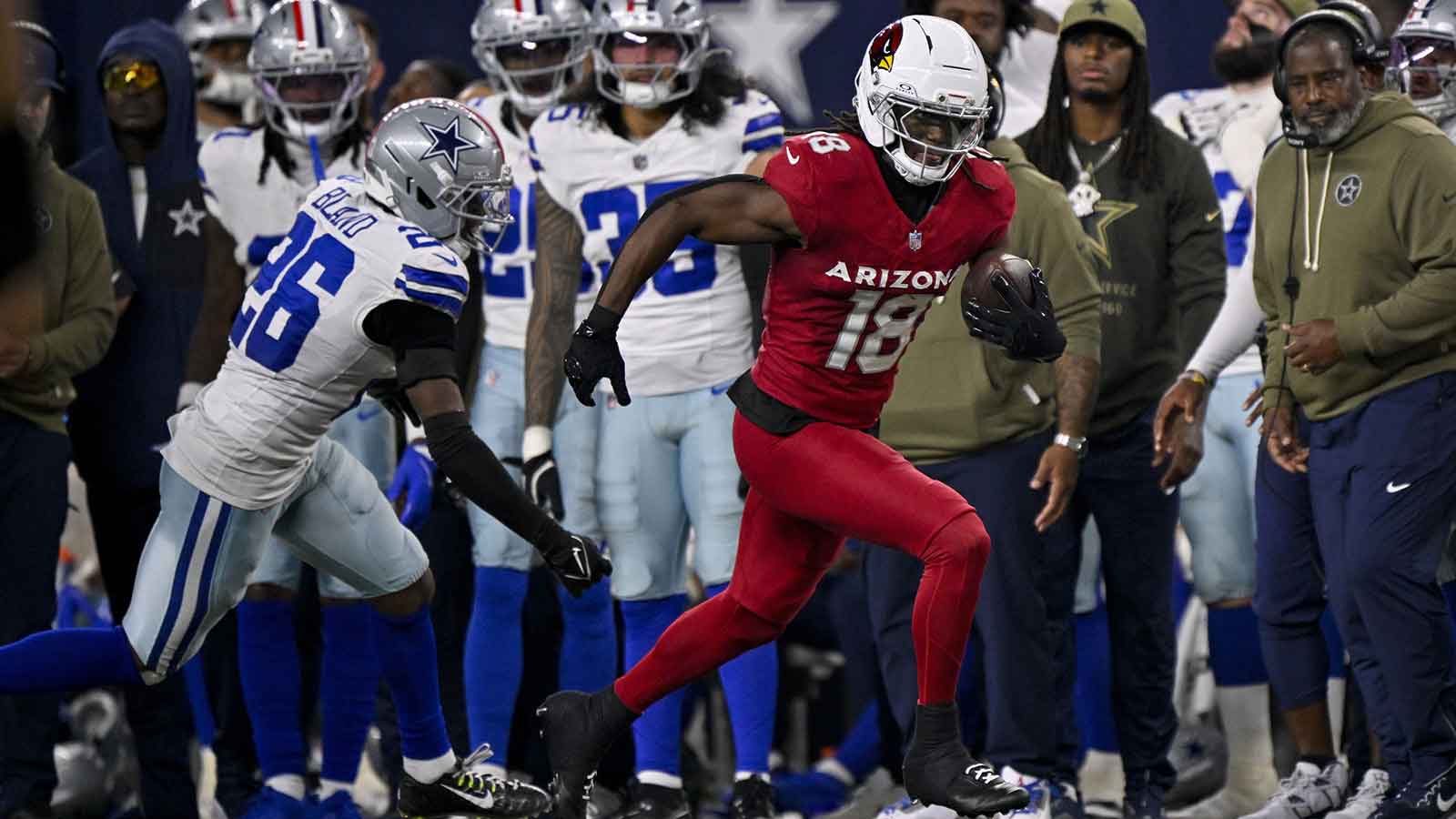 Arizona Cardinals wide receiver Marvin Harrison Jr. (18) runs with the ball past Dallas Cowboys cornerback DaRon Bland (26) during the game between the Dallas Cowboys and the Arizona Cardinals at AT&T Stadium.
