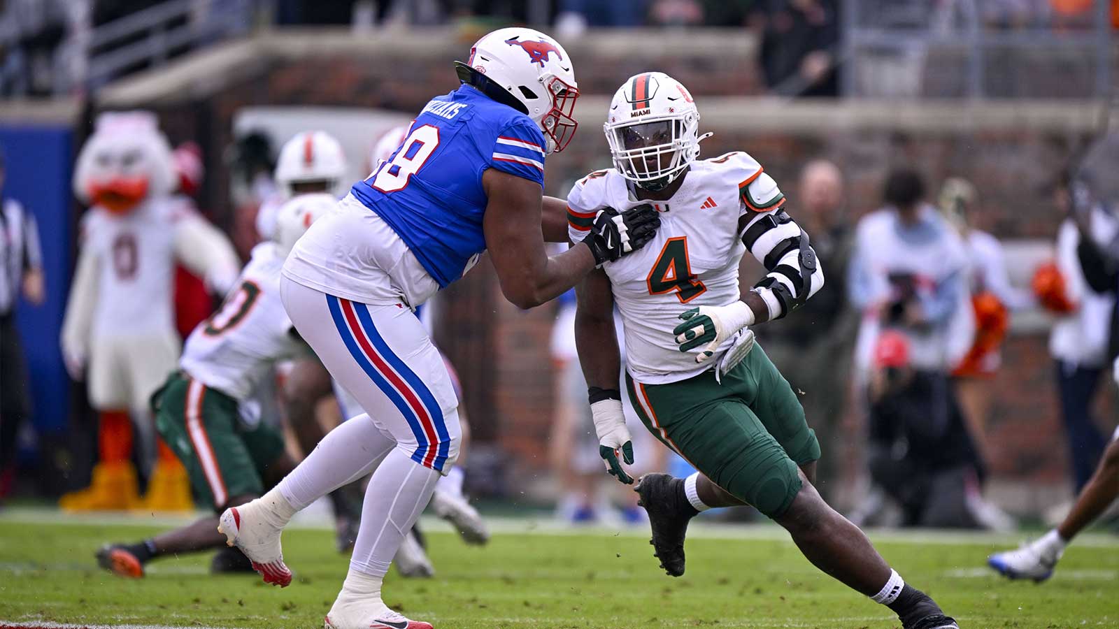SMU Mustangs offensive lineman PJ Williams (59) blocks Miami Hurricanes defensive lineman Rueben Bain Jr. (4) during the game between the Mustangs and the Hurricanes at Gerald J. Ford Stadium.