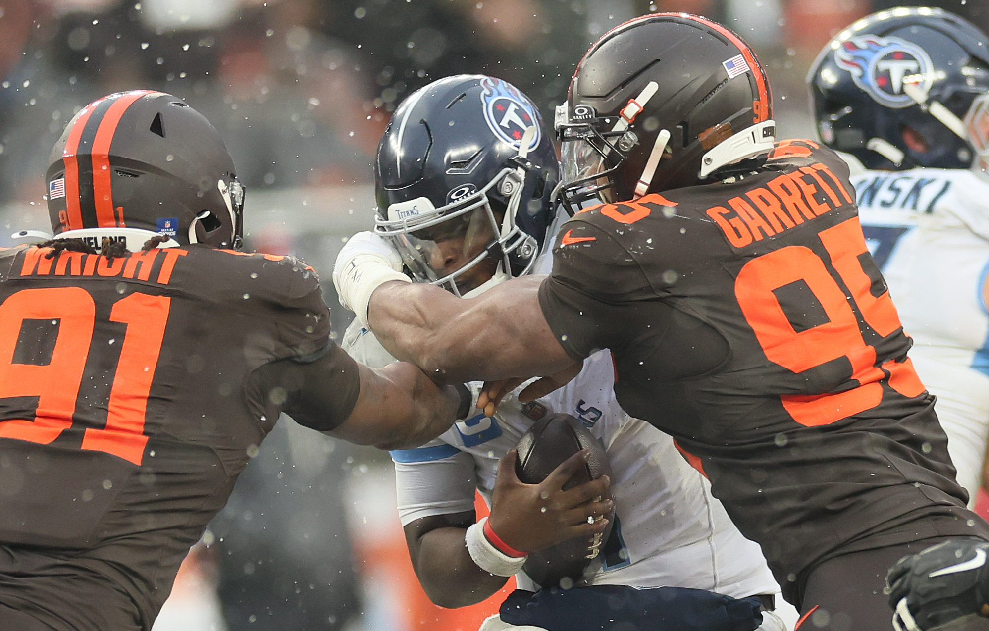 Cleveland Browns defensive end Myles Garrett (R) and Cleveland Browns defensive end Alex Wright get to Tennessee Titans quarterback Cam Ward for a sack in the first half at Huntington Bank Field.