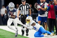 Dallas Cowboys wide receiver Kavontae Turpin (9) is pulled out of bounds by Los Angeles...
