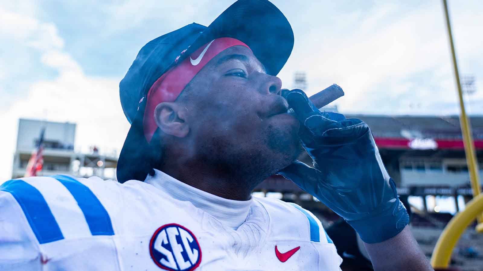 Ole Miss defensive lineman Zxavian Harris (51) smokes a cigar after a college football game between Mississippi State and Ole Miss at Davis Wade Stadium in Starkville, Miss., on Friday, Nov. 28, 2025. Ole Miss defeated Mississippi State 38-19 in the Egg Bowl.