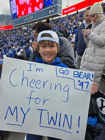 August “Augie” Watabe holds up a sign during BYU game this fall.