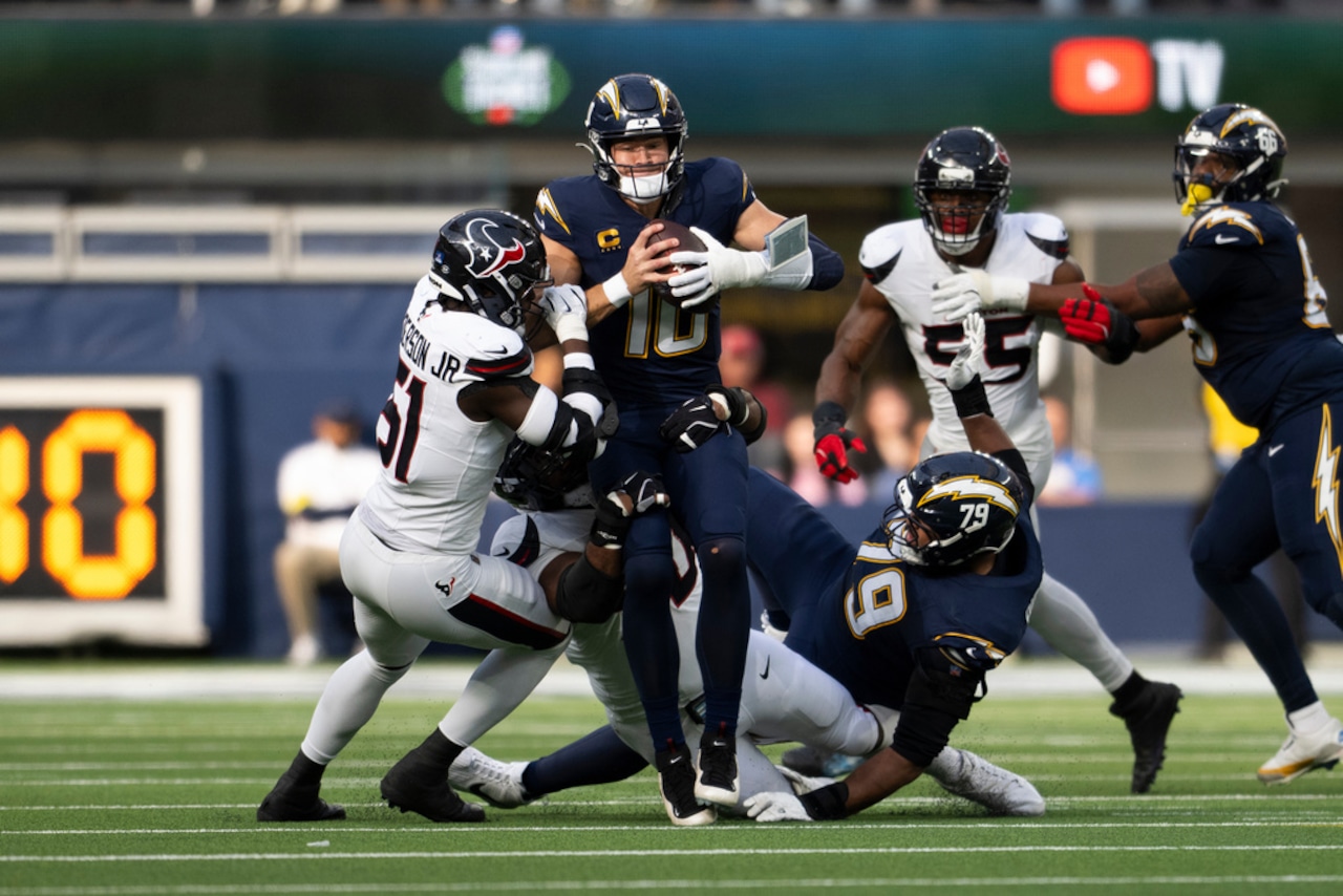 Houston Texans defensive end Will Anderson Jr. takes down Los Angeles Chargers quarterback Justin Herbert during an NFL game on Saturday, Dec. 27, 2025, at SoFi Stadium in Inglewood, Calif.
