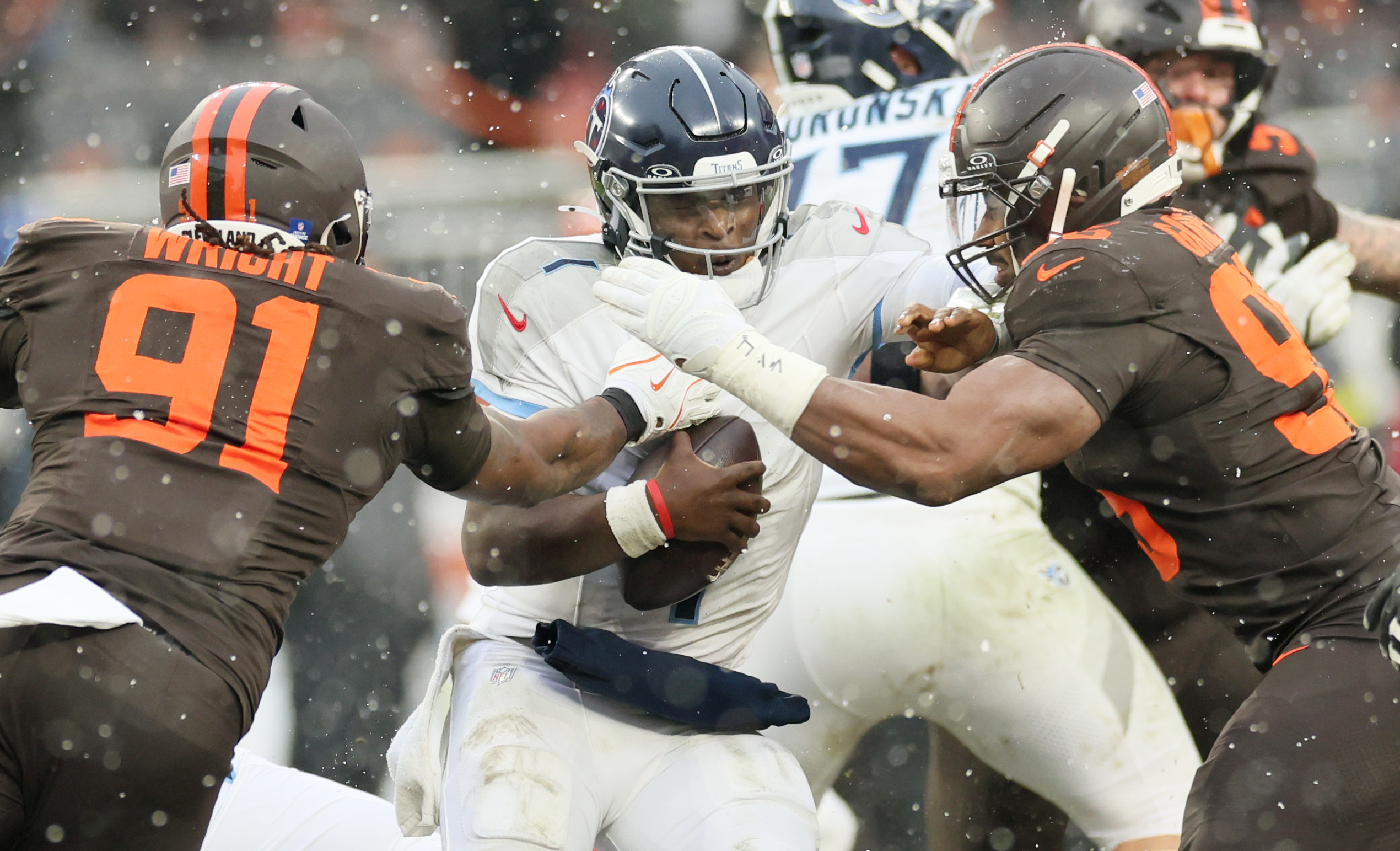 Cleveland Browns defensive end Myles Garrett (R) and Cleveland Browns defensive end Alex Wright get to Tennessee Titans quarterback Cam Ward for a sack in the first half at Huntington Bank Field.