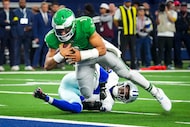 Philadelphia Eagles quarterback Jalen Hurts (1) gets past Dallas Cowboys safety Donovan...