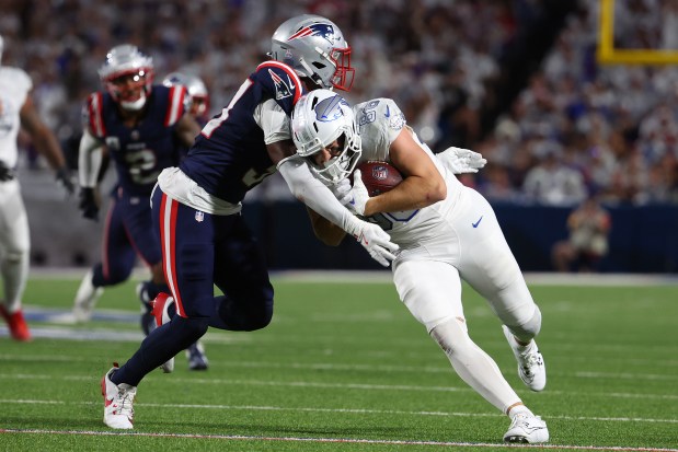 ORCHARD PARK, NEW YORK - OCTOBER 05: Dalton Kincaid #86 of the Buffalo Bills makes a catch and is tackled by Craig Woodson #31 of the New England Patriots in the third quarter of the game at Highmark Stadium on October 05, 2025 in Orchard Park, New York. (Photo by Timothy T Ludwig/Getty Images)