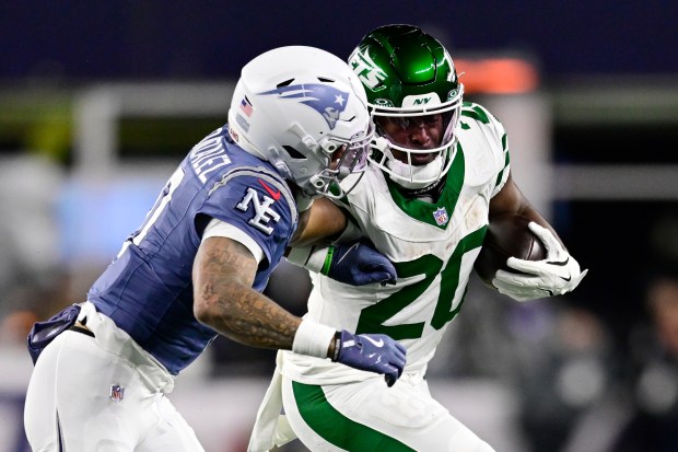 FOXBOROUGH, MASSACHUSETTS - NOVEMBER 13: Breece Hall #20 of the New York Jets is pursued by Christian Gonzalez #0 of the New England Patriots during the second half of a game at Gillette Stadium on November 13, 2025 in Foxborough, Massachusetts. (Photo by Jaiden Tripi/Getty Images)