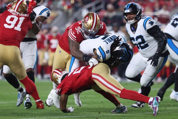 SANTA CLARA, CALIFORNIA - NOVEMBER 24: Rico Dowdle #5 of the Carolina Panthers is tackled by Jordan Elliott #92 of the San Francisco 49ers in the first quarter of the game at Levi's Stadium on November 24, 2025 in Santa Clara, California. (Photo by Jed Jacobsohn/Getty Images)