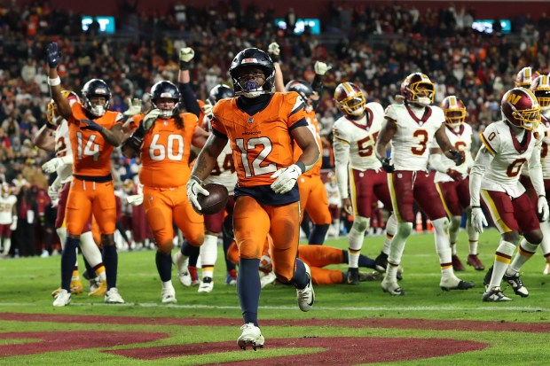 LANDOVER, MARYLAND - NOVEMBER 30: RJ Harvey #12 of the Denver Broncos scores a rushing touchdown against the Washington Commanders during overtime at Northwest Stadium on November 30, 2025 in Landover, Maryland. (Photo by Patrick Smith/Getty Images)