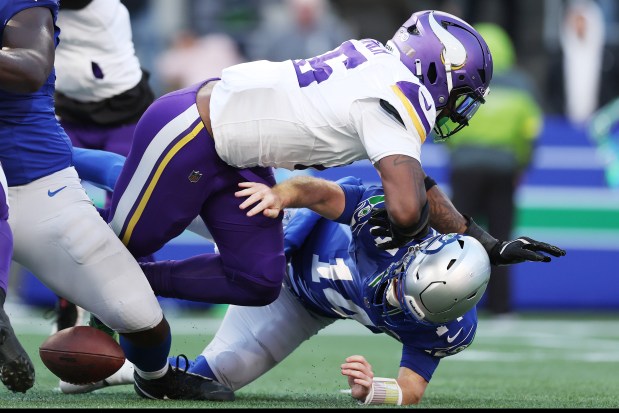 SEATTLE, WASHINGTON - NOVEMBER 30: Sam Darnold #14 of the Seattle Seahawks fumbles the ball while being hit by Dallas Turner #15 of the Minnesota Vikings in the second quarter of a game at Lumen Field on November 30, 2025 in Seattle, Washington. (Photo by Steph Chambers/Getty Images)