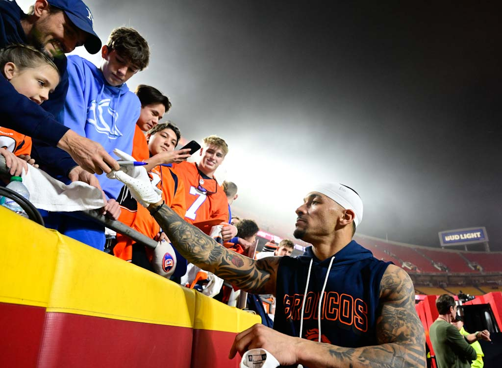 Denver Broncos tight end Evan Engram (1) signs autographs before...
