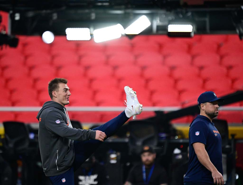 Denver Broncos quarterback Bo Nix (10) stretches one field before...