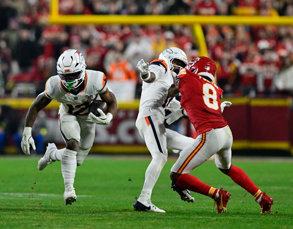Denver Broncos running back RJ Harvey (12) finds running room...
