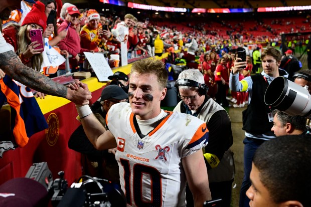 KANSAS CITY, MO - DECEMBER 25: Denver Broncos quarterback Bo Nix (10) walks off the field and greets fans after defeating the Kansas City Chiefs 20-13 at GEHA Field at Arrowhead Stadium in Kansas City, Missouri on Thursday, December 25, 2025. (Photo by Andy Cross/The Denver Post)