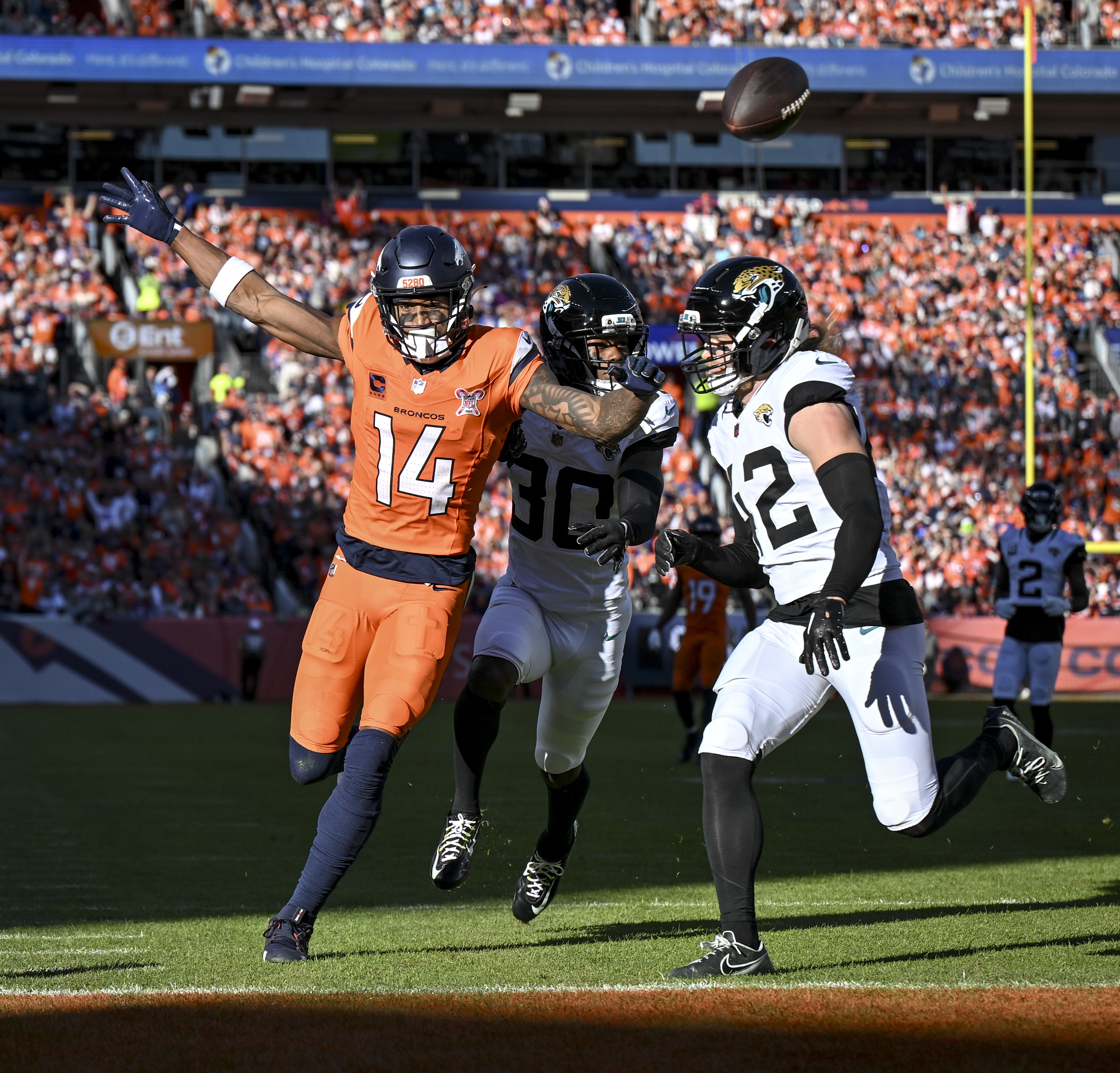 Andrew Wingard (42) and Montaric Brown (30) of the Jacksonville...