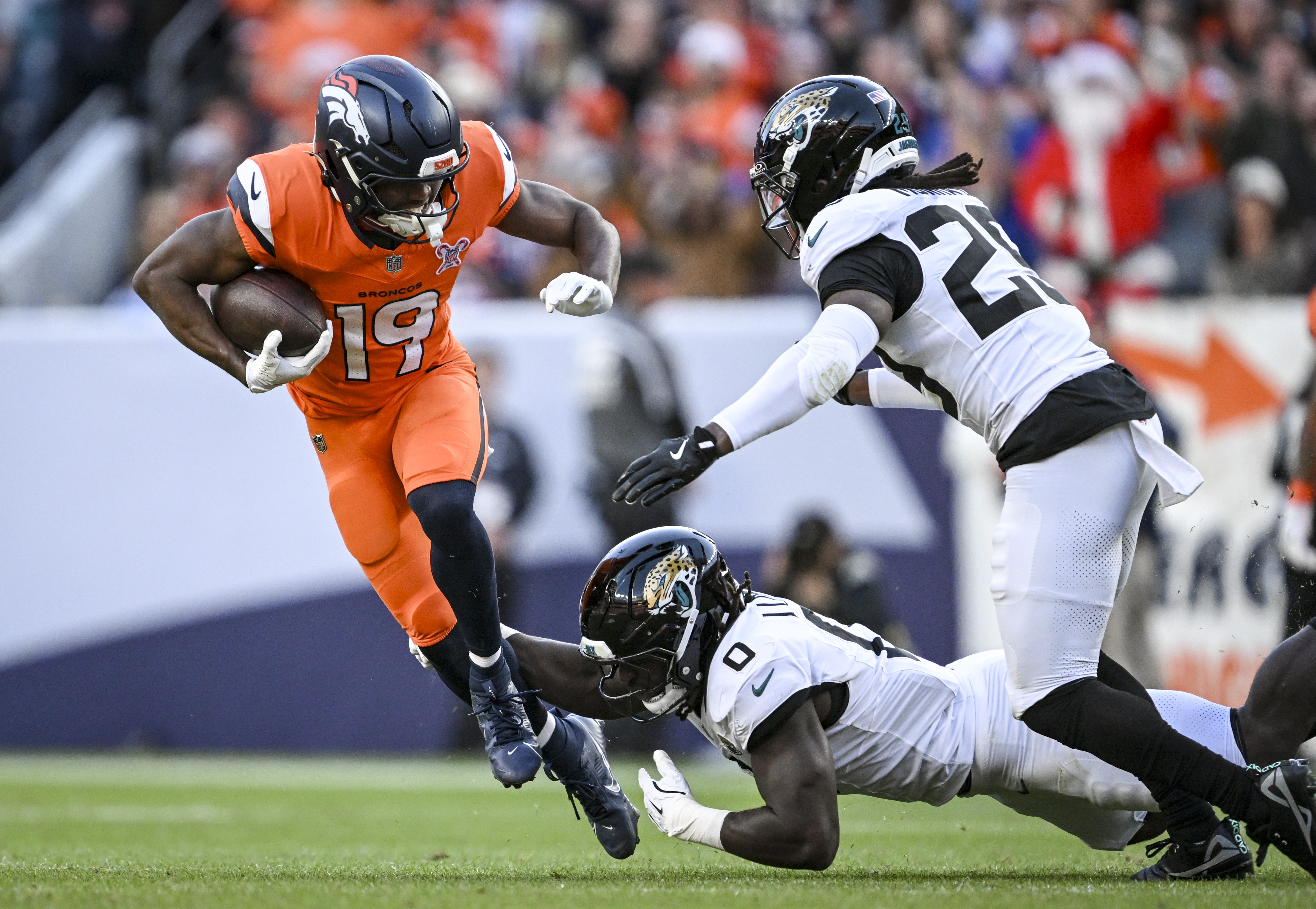 Marvin Mims Jr. (19) of the Denver Broncos runs through...