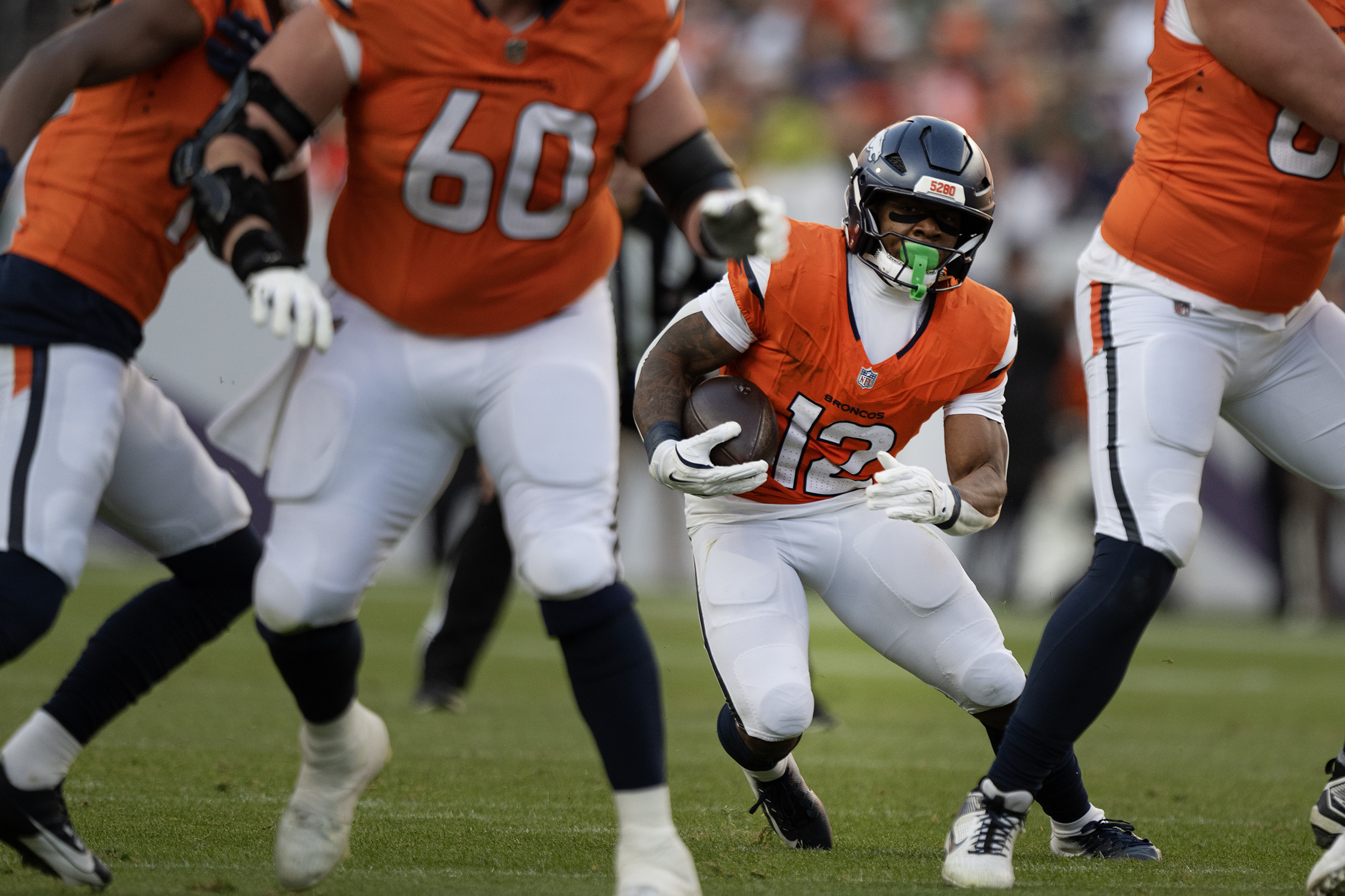 Running back RJ Harvey (12) of the Denver Broncos finds...