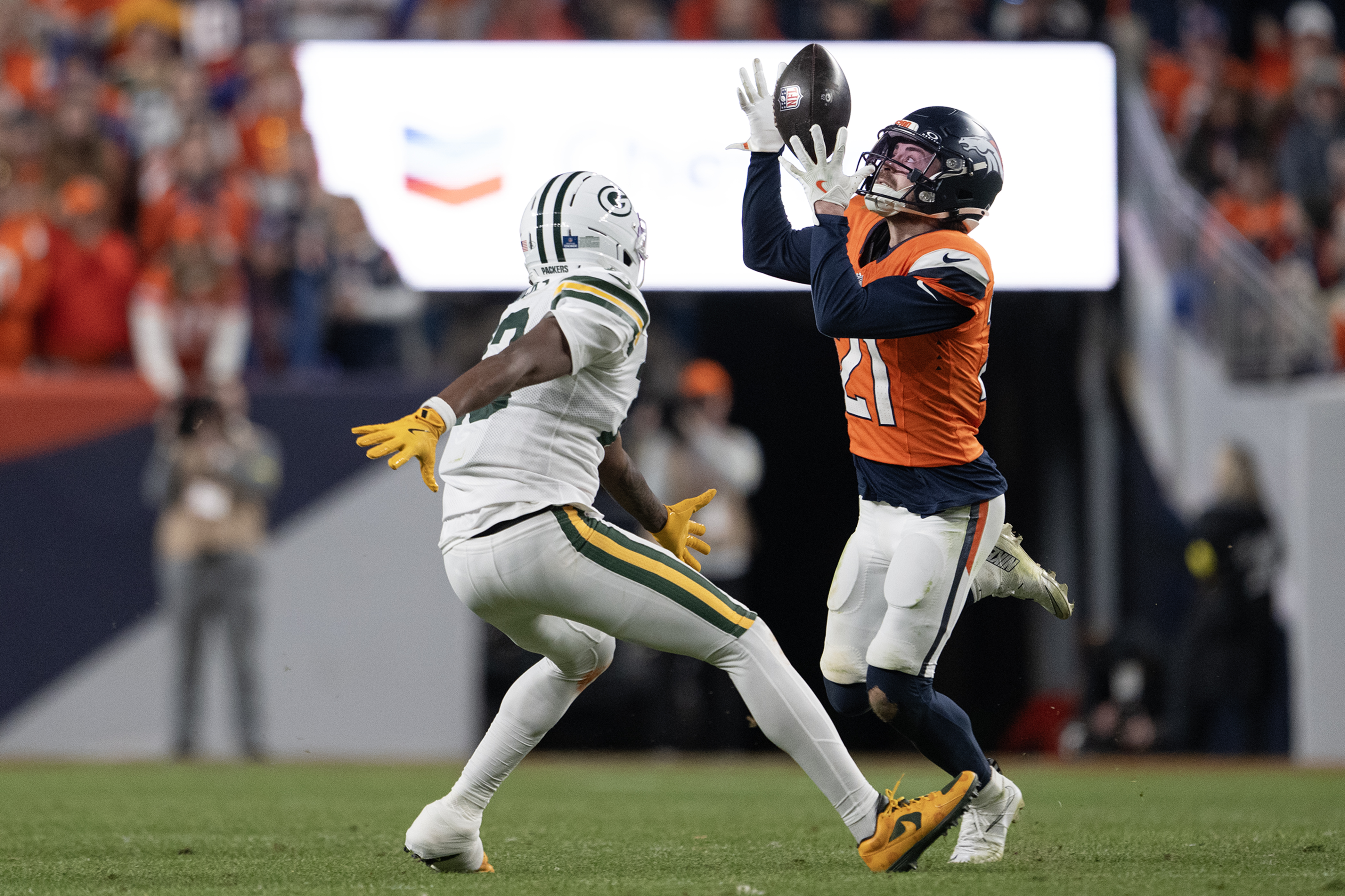 Cornerback Riley Moss (21) of the Denver Broncos intercepts a...