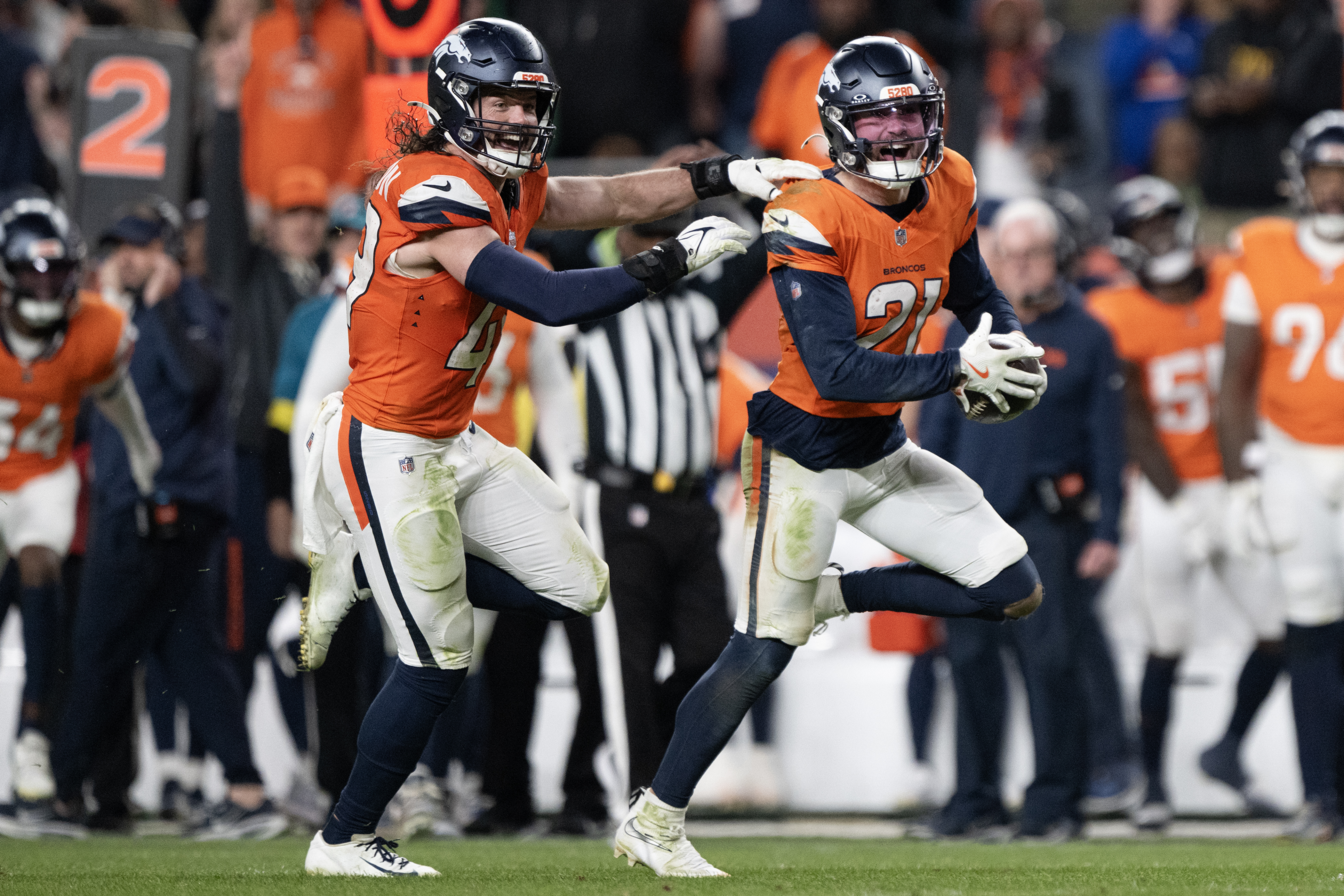 Cornerback Riley Moss (21) of the Denver Broncos celebrates an...