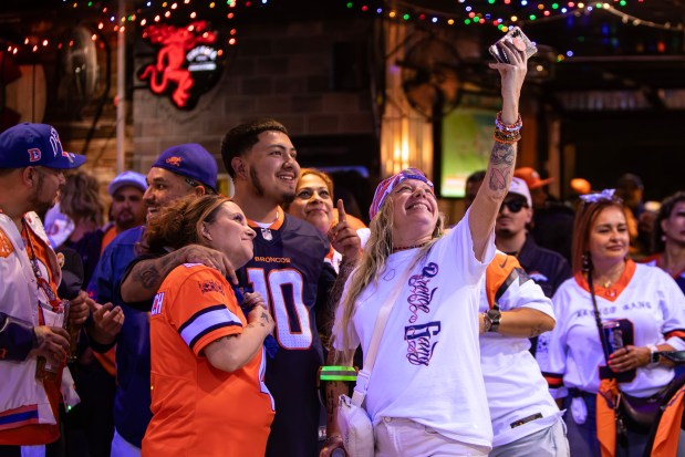 Bronco Gang members socialize as they wait for Andrew Young, known as Mad Fanatic, to perform at The Point Sports Bar and Grill in Thornton on Saturday, Nov. 15, 2025. (Photo by McKenzie Lange/Special to The Denver Post)
