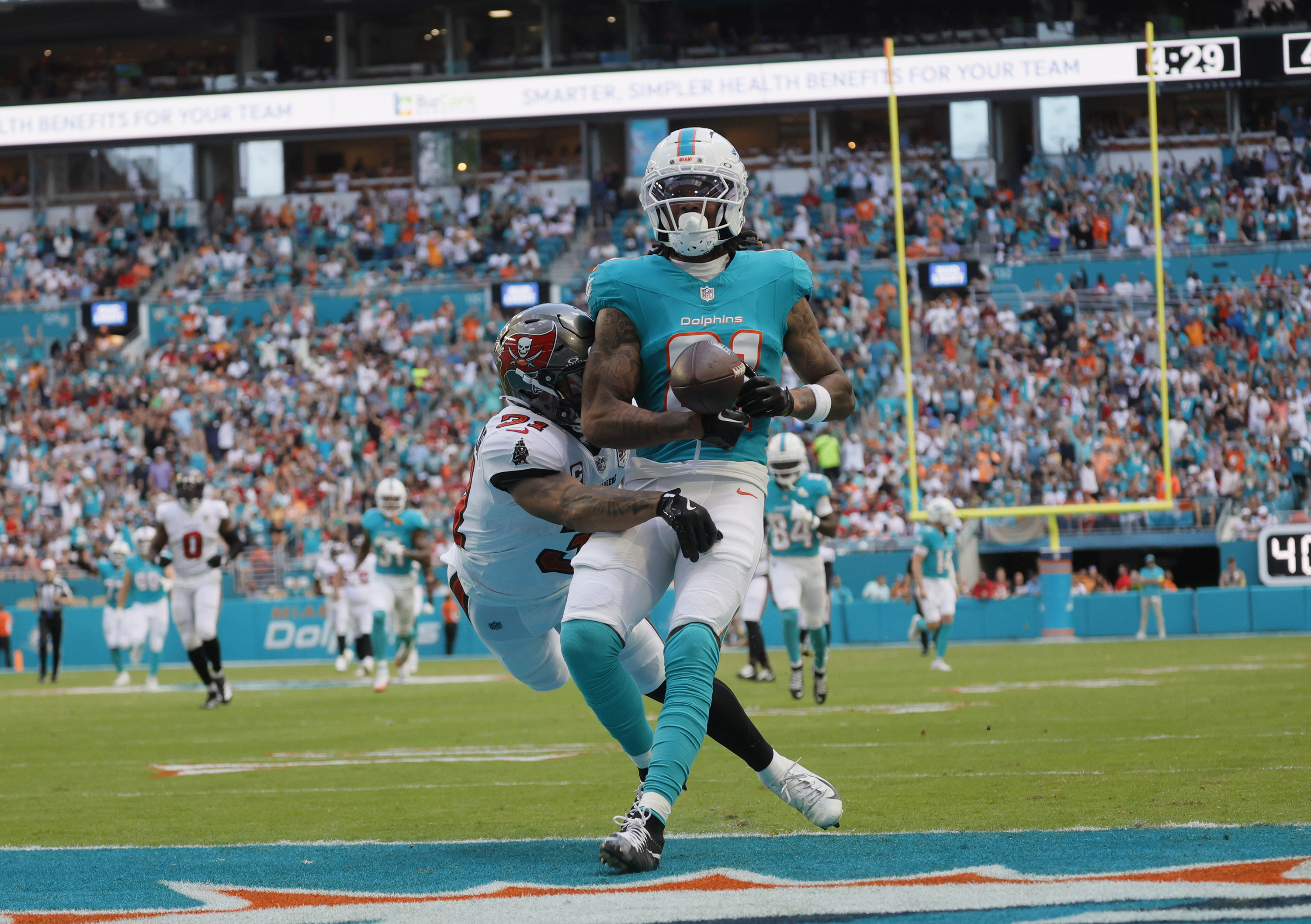 Miami Dolphins wide receiver Theo Wease Jr. (81) scores a...