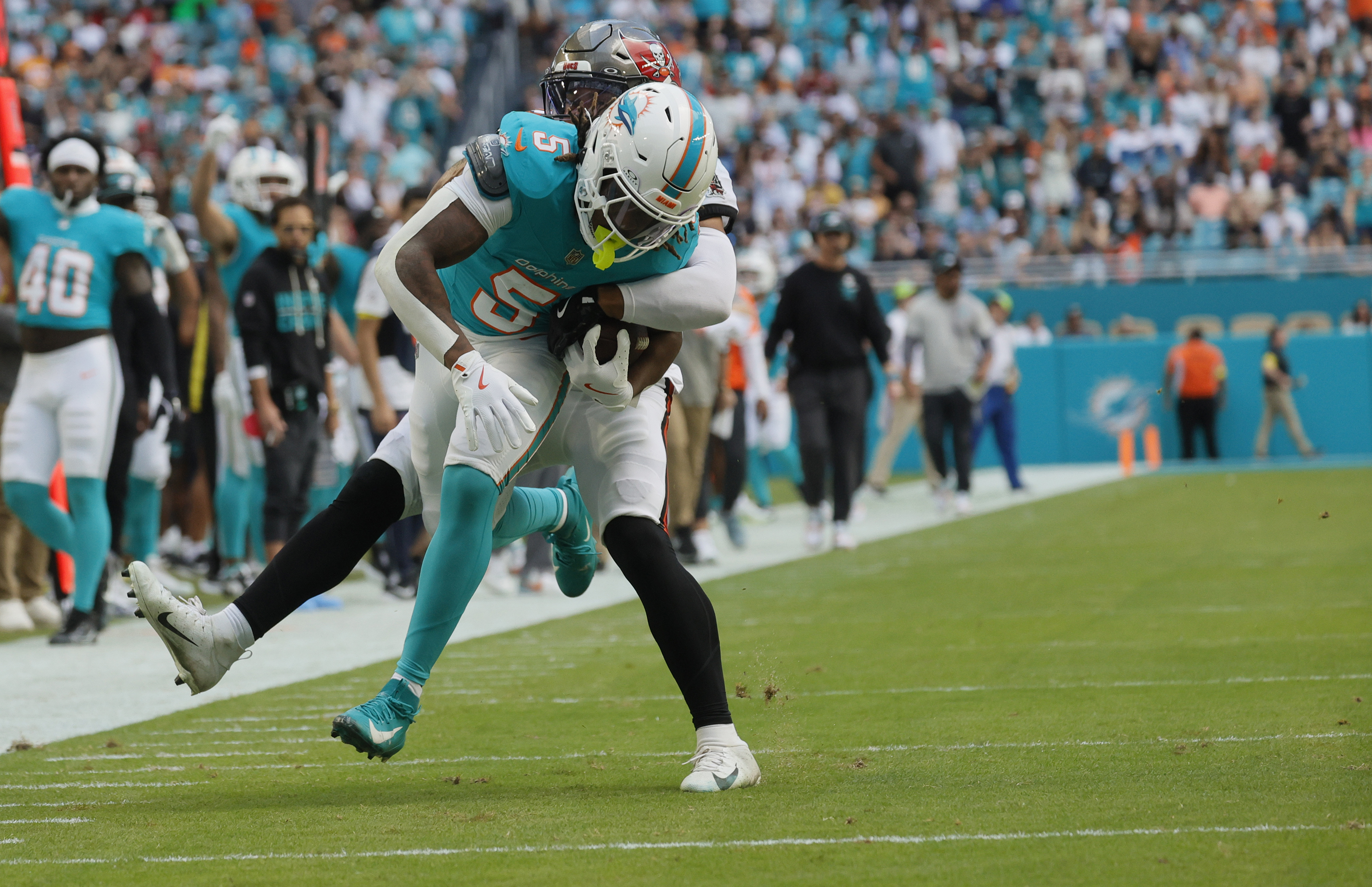 Miami Dolphins running back Jaylen Wright (5) runs for a...