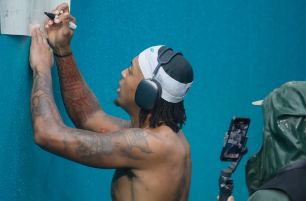 Miami Dolphins running back Ollie Gordon II (31) signs for...