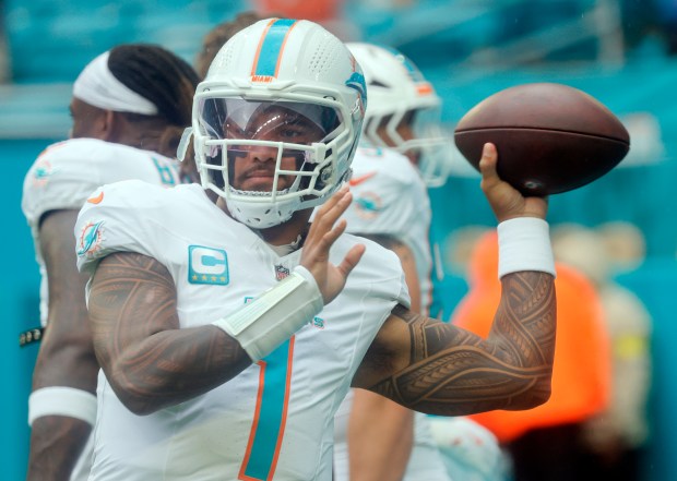 Miami Dolphins quarterback Tua Tagovailoa (1) warms up before the...