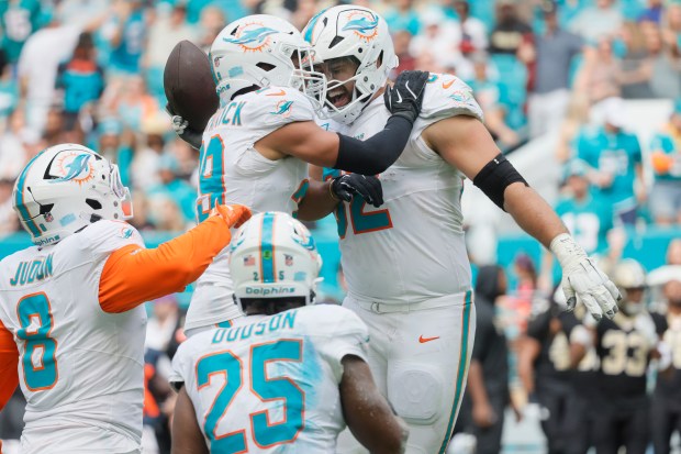 Miami Dolphins defense celebrates a fumble recovery by defensive tackle Zach Sieler (92) Sunday, Nov. 30, 2025, at the Hard Rock Stadium in Miami Gardens. (Joe Cavaretta/South Florida Sun Sentinel)