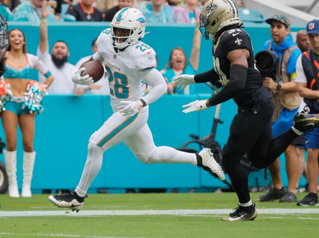 Miami Dolphins running back De'Von Achane (28) runs in a...